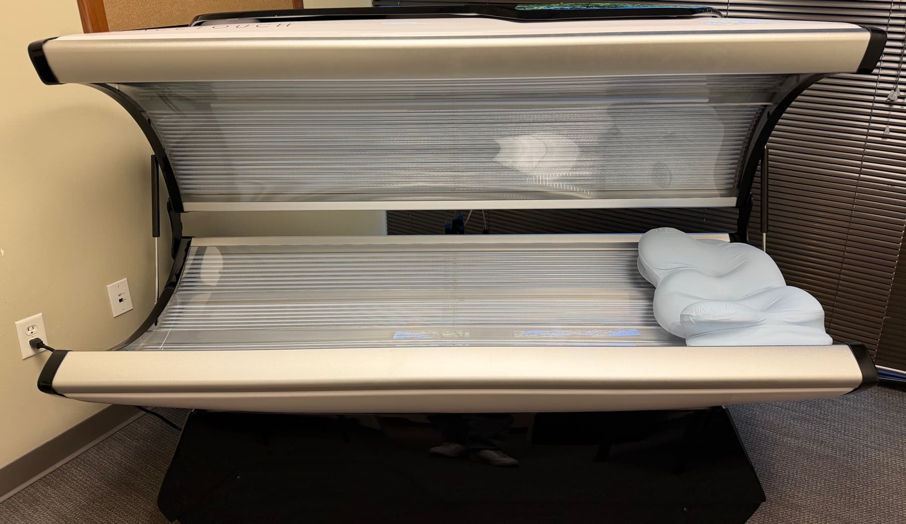 The SpaceTouch capsule open and ready for a session, with a pillow inside