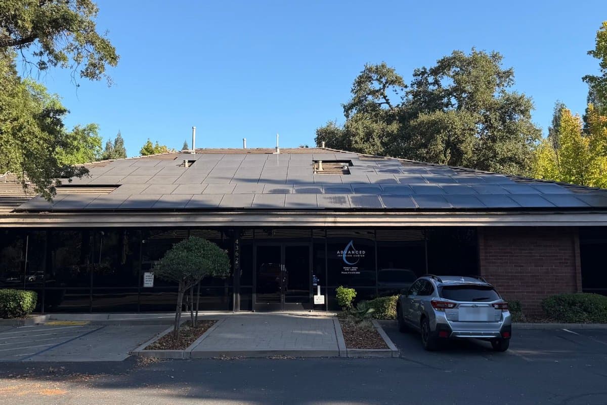 The front of Advanced Infusion Center at 4362 Auburn Blvd — a single-storey brick building with a glass entrance and the clinic's logo on the door.